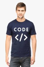 A person is wearing the Techie's Classic T-Shirt—navy blue with the text "CODE" and enhanced by HTML tag symbols. The minimalist backdrop creates a striking contrast, highlighting the subtle nod to Looga-inspired design elements.