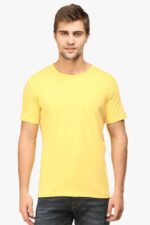 A person is wearing one of Looga's best plain T-shirts for men in a vibrant yellow hue, paired with dark jeans, against a light gray background. This short-sleeved T-shirt boasts a classic round neck design.