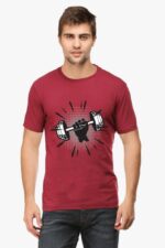 A man models the Looga Premium Fitness T-Shirt for Health & Fitness Enthusiasts, which proudly features a graphic of a fist gripping a dumbbell, accented by dynamic lines to convey motion. Complemented by dark jeans, he stands against a minimalist white backdrop.