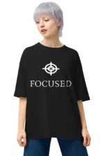 Fashion-forward: Woman in black ‘FOCUSED’ t-shirt paired with a chic laptop bag.