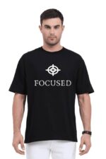 A person wearing the Unisex Oversized T Shirt from Looga, featuring the word FOCUSED and a target symbol, stands confidently against a plain white background. With short dark hair, they exude an aura of tranquility, embodying the spirit of Looga in every fiber.