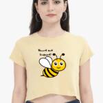 A stylish woman crop top in a vibrant yellow hue, featuring a playful ‘Bee kind’ graphic