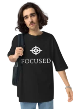 Casual and trendy, a person showcases a black ‘FOCUSED’ t-shirt and carries a stylish laptop bag.