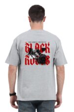 A man wearing an oversized T-shirt from Looga, featuring bold red text that reads "YOU SMELL PATHETIC" and "BLACK ROSES" against a gray background, complements the striking black rose illustration that adds an edgy touch to his style.
