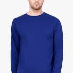 A South Asian male model with short hair, wearing a comfortable men's round neck full sleeve t-shirt in a neutral color