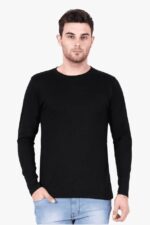 A man wearing a Looga Mens Round Neck Full Sleeve T-Shirt for ultimate comfort and style in black, paired with light blue jeans, stands against a plain white background, his right hand casually tucked into his pocket.