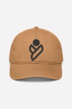 A tan baseball cap with a distinctive dark brown logo