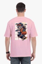 Someone wears a Looga Unisex Oversized T-shirt featuring a cartoon werewolf skating with a pumpkin on the back, surrounded by bats.