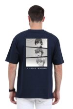 Wearing a dark Unisex Oversized Anime TShirt from Looga, featuring three black-and-white manga-style character panels and bold I LOVE MANGA text on the back, the short-haired individual stands facing away from the camera.