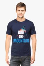 A man sports an Adventure T-Shirt for Men by Looga, showcasing Ride the Mountain in bold white and blue letters. A vibrant mountain biker image enhances his navy blue tee as he poses against a plain white backdrop.