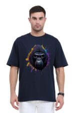 A man clad in a Unisex Oversized Classic T-Shirt with a vibrant gorilla graphic and Looga-inspired splashes of yellow, purple, and blue surrounding the gorilla's face is set against a plain white backdrop.