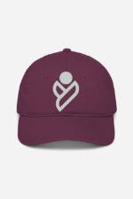 A maroon baseball cap, from the Looga collection, features a white abstract logo prominently at its center. The geometric design adds a unique flair to this unisex accessory. It includes a curved brim and a subtly hidden adjustable strap, all set against a plain white background.