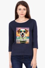 A woman wearing a navy full-sleeve Looga pet lovers t-shirt for women, showcasing a dog in sunglasses and a life jacket against a beach sunset background. The shirt text says On Vacation.