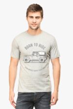 A man in a Thar Lovers T-Shirt featuring a vintage car and the text BORN TO RIDE and FOUR WHEELS MOVE YOUR LOOGA stands against a white background.