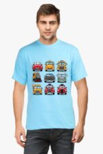 A man poses in a light blue Cartoon Cars T-shirt by Looga against a plain white background, his short hair enhancing the casual vibe. The whimsical design features colorful cars and a train, reminiscent of a playful Looga storybook.