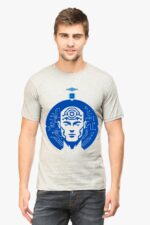 A person wearing an AI-Inspired T-Shirt by Looga, featuring a blue futuristic face with circuit-like patterns and an extra eye on the forehead against a light gray background, stands against a plain white backdrop.