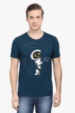 A person confidently models the blue AI Design T-Shirt by Looga, featuring a cute, smiling robot on the front, standing against a plain white background. With short hair and charisma, they embody Loogas spirit of innovation.