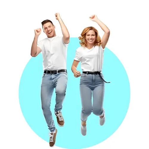 Energetic duo in Unisex Standard T-Shirts leaping with joy, showcasing casual style and comfort