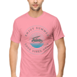 The image shows a person wearing a pink summer t-shirt with a graphic design on the front. The design includes text and an illustration of what appears to be a boat on water.