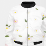 A white bomber jacket for women with a black collar, cuffs, and hem featuring a floral pattern of pink daisies with yellow centers and green leaves. The jacket has a front zipper and two side pockets.