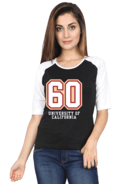 A woman with long hair is wearing a black and white raglan t-shirt featuring the number 60 and the words University of California. She is also wearing blue jeans and standing against a plain background.