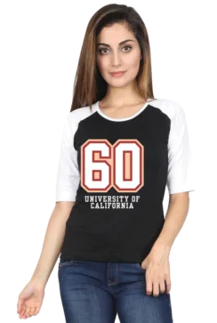 A woman with long hair is wearing a black and white raglan t-shirt featuring the number 60 and the words University of California. She is also wearing blue jeans and standing against a plain background.