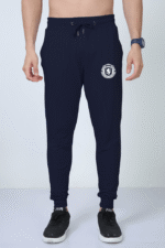 A man is dressed in the Premium Joggers for Men from Looga, which feature a captivating white lion emblem on the left pocket area. Complementing his look, he's accessorized with a smartwatch and black sneakers with white soles. The plain white background accentuates the sophistication of his attire.