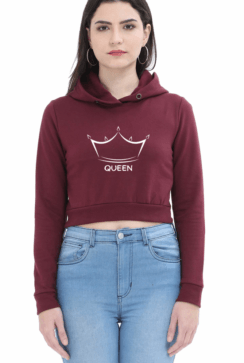 A person wearing a maroon crop hoodie with a crown graphic and the word QUEEN on the front, paired with light blue jeans, stands against a plain white background.
