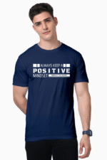 A man wearing a navy Unisex Supima T-Shirt, Premium Soft Cotton Tee for Men & Women, with the text Always keep a positive mindset, embrace the journey, has short dark hair and a watch on his left wrist.