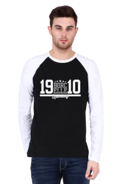 A man in a stylish raglan t-shirt stands against a plain background, his white and black shirt featuring the bold text "BORCELLE 19 10.