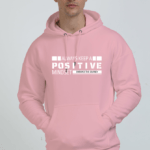 Person wearing a pink hoodie with the text "Always Keep a Positive Mindset" on the front.