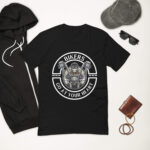 Looga Black T-Shirt for Bikers - Comfort Meets Style: A black tee featuring a skull in a helmet between motorcycle handlebars with BIKERS GO AT YOUR HEART, paired with a black hoodie, gray cap, sunglasses, brown wallet, and bracelets for the perfect Looga vibe.