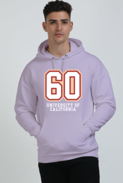 Wearing a stylish Lavender hoodie with 60 and University of California on the front, a person with short dark hair confidently stands against a plain background, effortlessly showcasing the perfect mix of heavyweight hoodies and style.