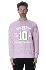 A person wears a Light Baby Pink unisex sweatshirt with Rimberio USA Borcellec University and the number 10 in green. Est. 1990 flanks the number, creating a trendy contrast against the pristine white background.