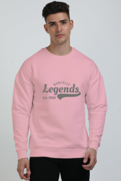 A person wearing a cozy oversized Light Baby Pink sweatshirt with Borcelle Legends Est. 1950 text, standing against a plain background.