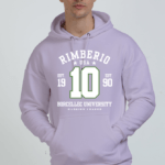 A person wears a light purple Heavy Cotton Hoodies - Comfort and Style for Every Season featuring Rimberio USA, Borcellec University, number 10, small stars, and Est. 1990. Standing against a plain background, it showcases the hoodie’s stylish comfort and durability.