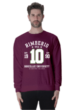 A bearded man is wearing a maroon unisex sweatshirt from Rimberios 1990 collection, displaying the text Rimberio USA, Est. 1990, 10, and Borcellec University Varsity Team.