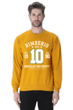 A man is wearing a Mustard Yellow unisex Rimberio sweatshirt with RIMBERIO USA 10 BORCELLE UNIVERSITY EST. 1990 elegantly printed in white and green.
