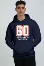 A person in a stylish heavyweight navy blue hoodie, featuring 60 and University of California on the front, stands confidently against a plain background. They gaze at the camera with hands casually in their pockets.