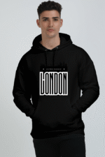 A person wearing a heavyweight black hooded sweatshirt named Black, featuring London, United Kingdom and a city skyline silhouette on the front, is standing against a plain background.