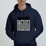 A person wearing a heavyweight navy blue hooded sweatshirt featuring the London skyline and LONDON in bold, white capital letters on the front against a plain white background.