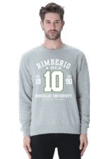 A man with short hair and a beard wears the Grey Melange unisex sweatshirt, featuring Rimberio USA, Borcellec University, bold green 10, and flanked by Est. 1990. This Rimberio 1990 classic offers a versatile style.