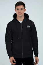 A person stands against a plain background wearing the Black1 hoodie, which features an embroidered emblem on the left chest. They look slightly off-camera with a neutral expression.