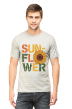A man wears the Product, a light grey T-shirt with "SUNFLOWER" in bold, colourful letters and a sunflower graphic replacing the O, standing against a plain background.