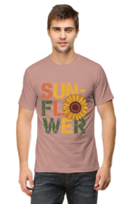 A man wears Product, a light mauve t-shirt with "SUNFLOWER" in distressed, colourful letters and a large sunflower graphic as the O.