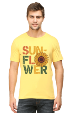 A man wears the product: a yellow T-shirt featuring “SUNFLOWER” in bold, distressed letters with a sunflower graphic as the “O”, against a plain light background.