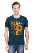 A man stands against a white background, wearing the product: a blue T-shirt featuring "SUNFLOWER" in bold colourful letters, with a sunflower graphic in place of the letter O.